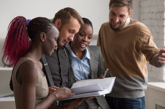 Coworkers reviewing a document together
